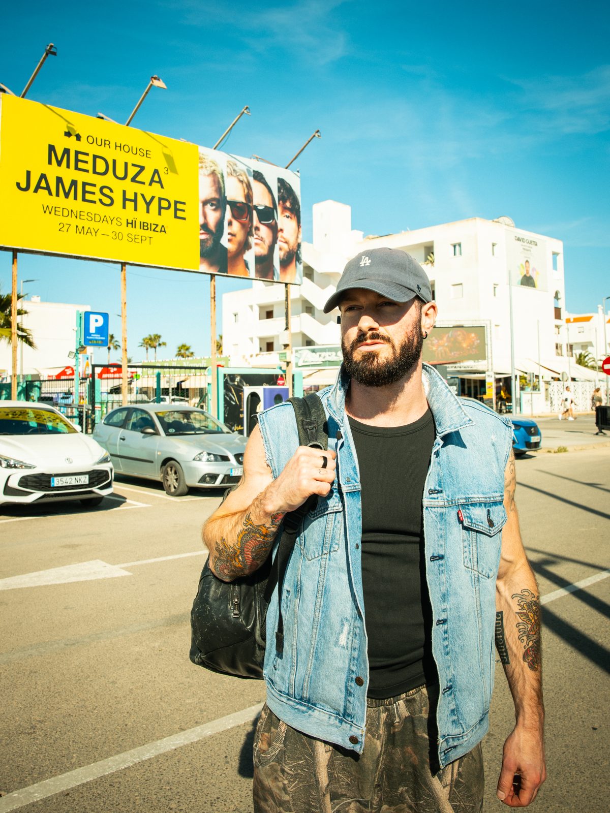 James Hype in front of the OUR HOUSE billboard, Playa d'en Bossa, Ibiza